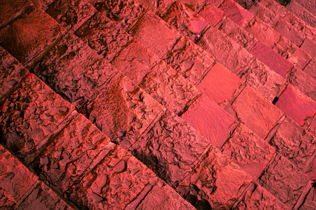 A close-up shot of a glowing pink Himalayan salt tile showing its crystalline texture and rich mineral veins